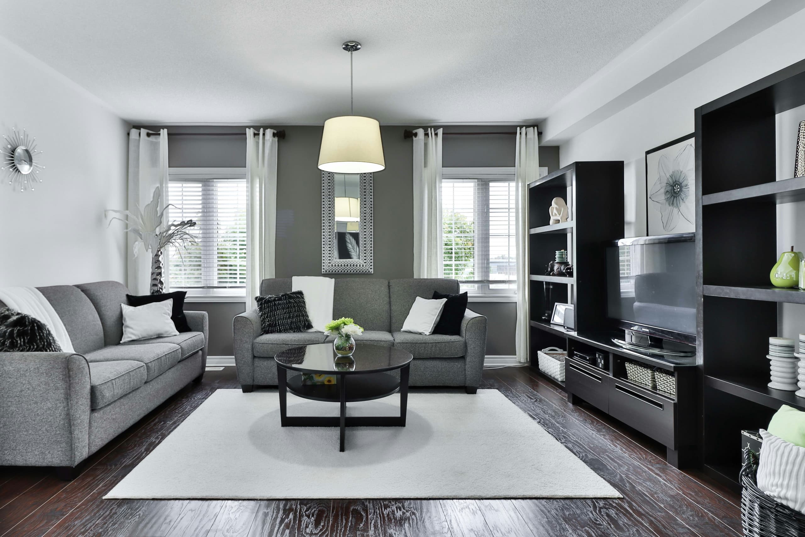 A reading chair set against tall curtains